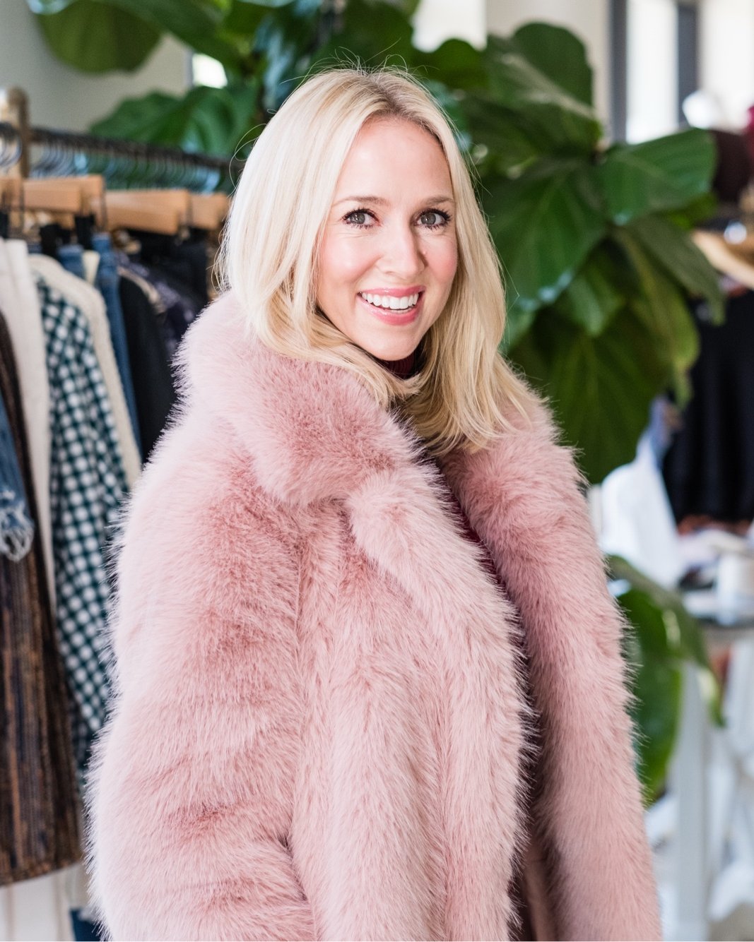 Lukka Boutique owner in a blush pink faux fur coat inside the Baton Rouge store